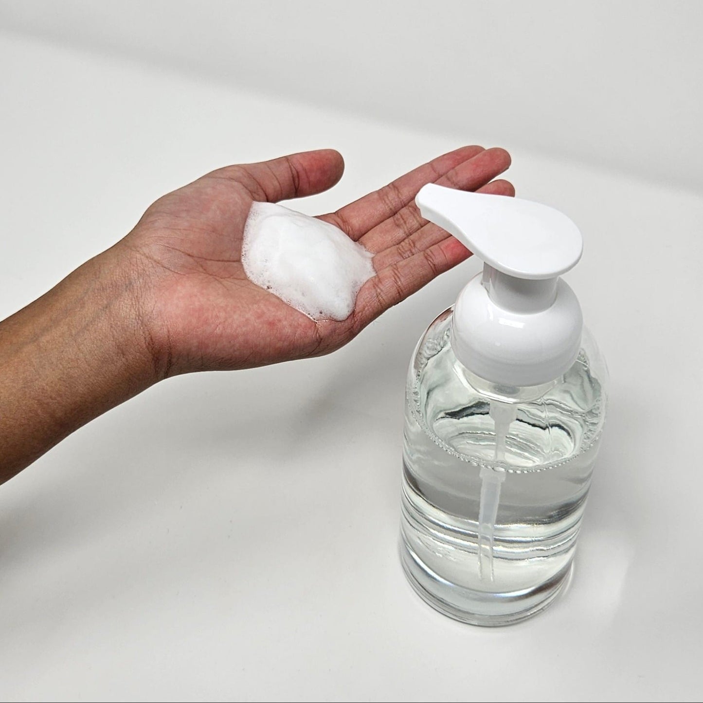 Glass bottle with foaming pump dispenser
