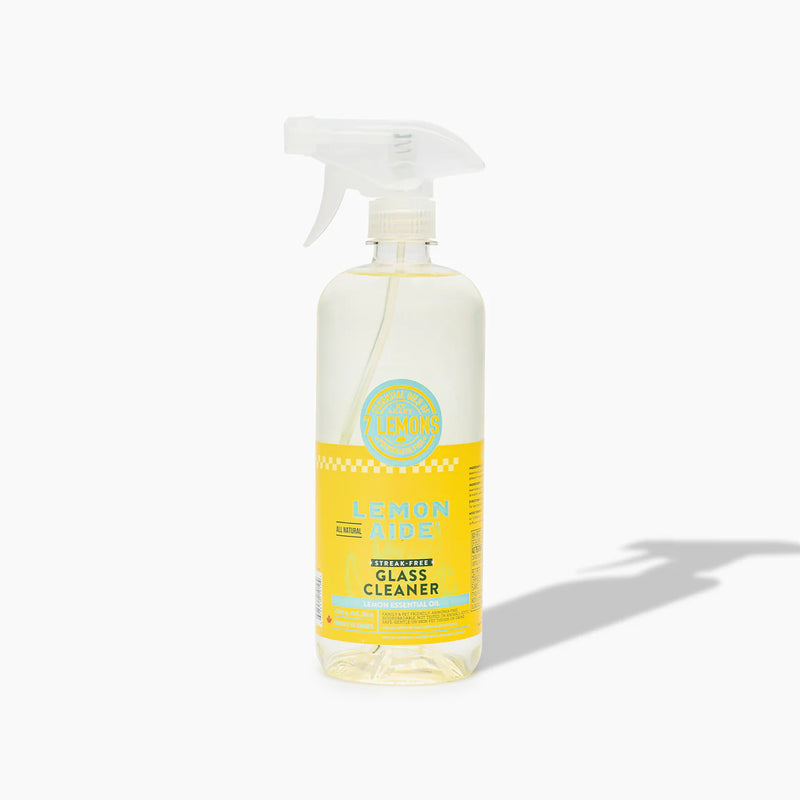 Bottle of lemon-scented glass cleaner on a white background