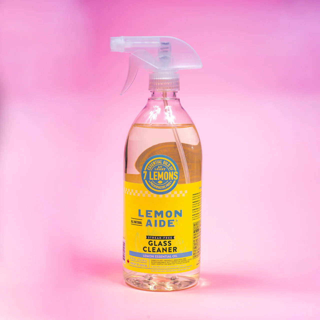 Bottle of Lemon Aide glass cleaner on a pink gradient background