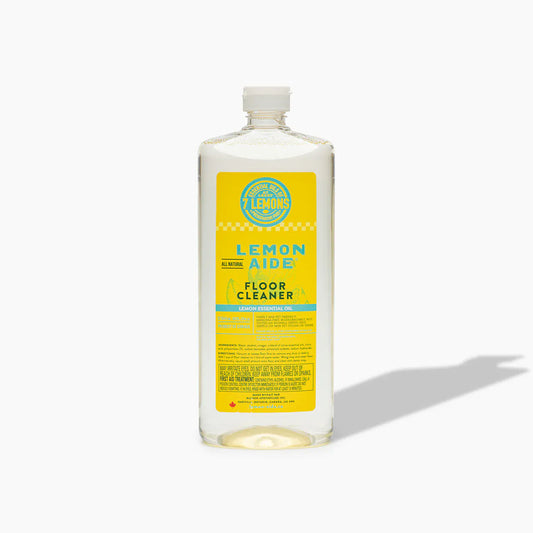 Bottle of Lemon Aid Floor Cleaner with a yellow label on a white background