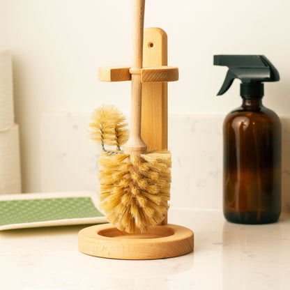 Bamboo cleaning brush set with a spray bottle on a bathroom counter.